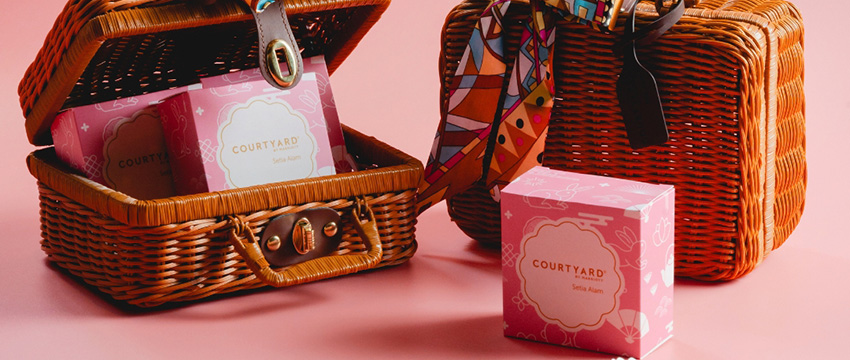 Woven baskets with pink boxes inside